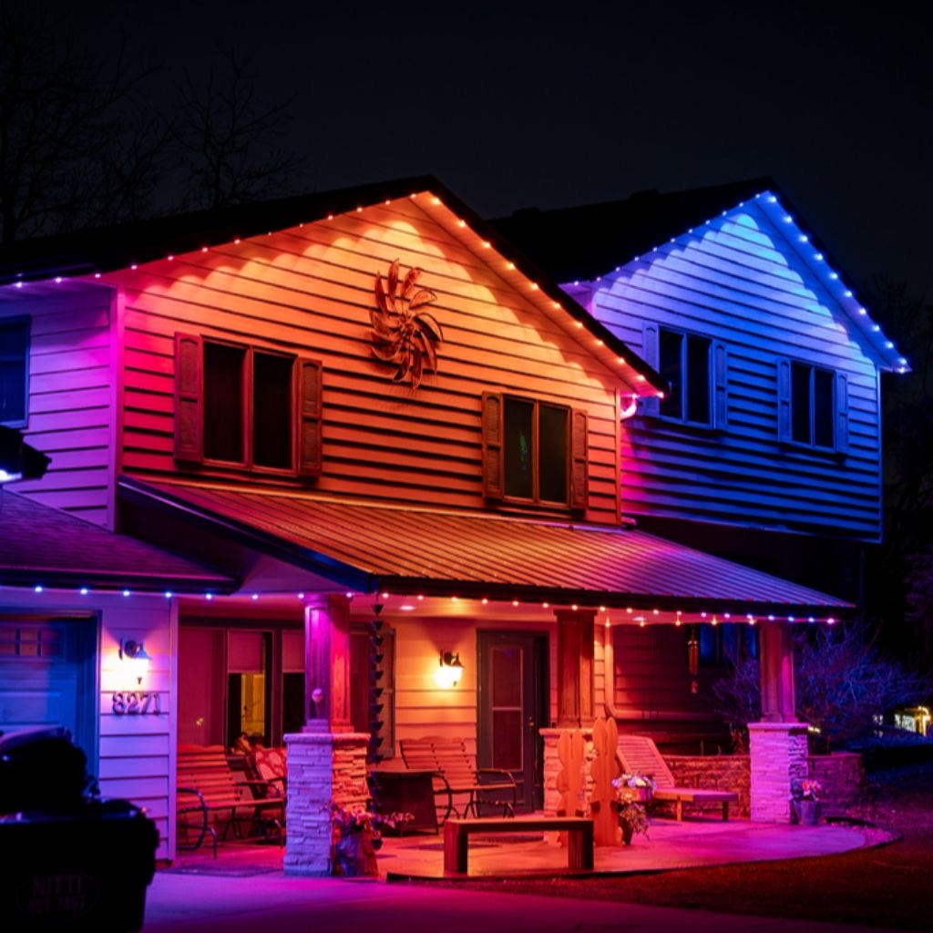 Two-story home with multi-color permanent lights over the gables and front porch